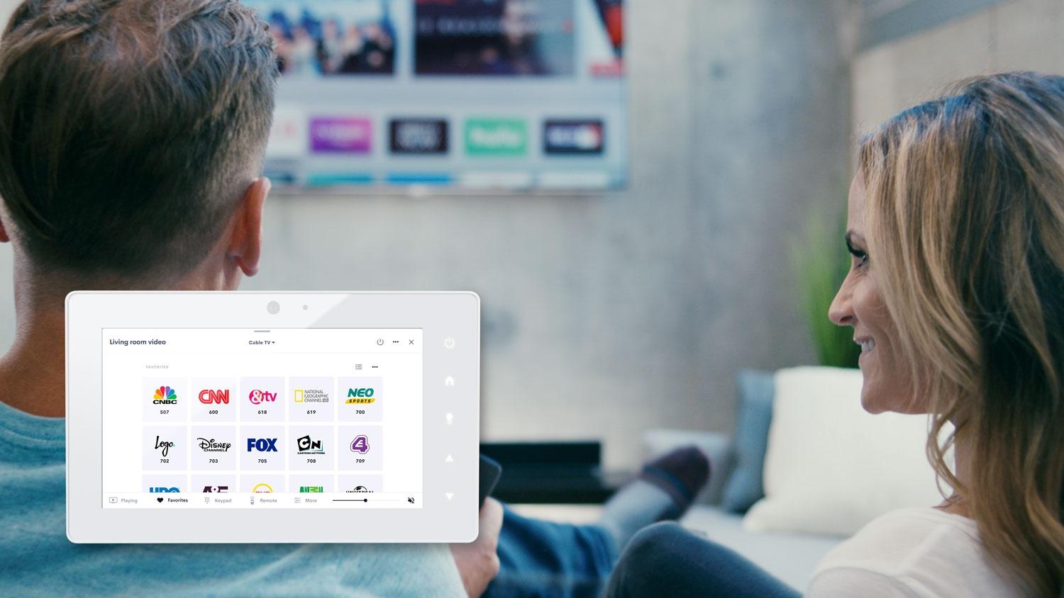 Couple watching tv together with white touch panel product photo