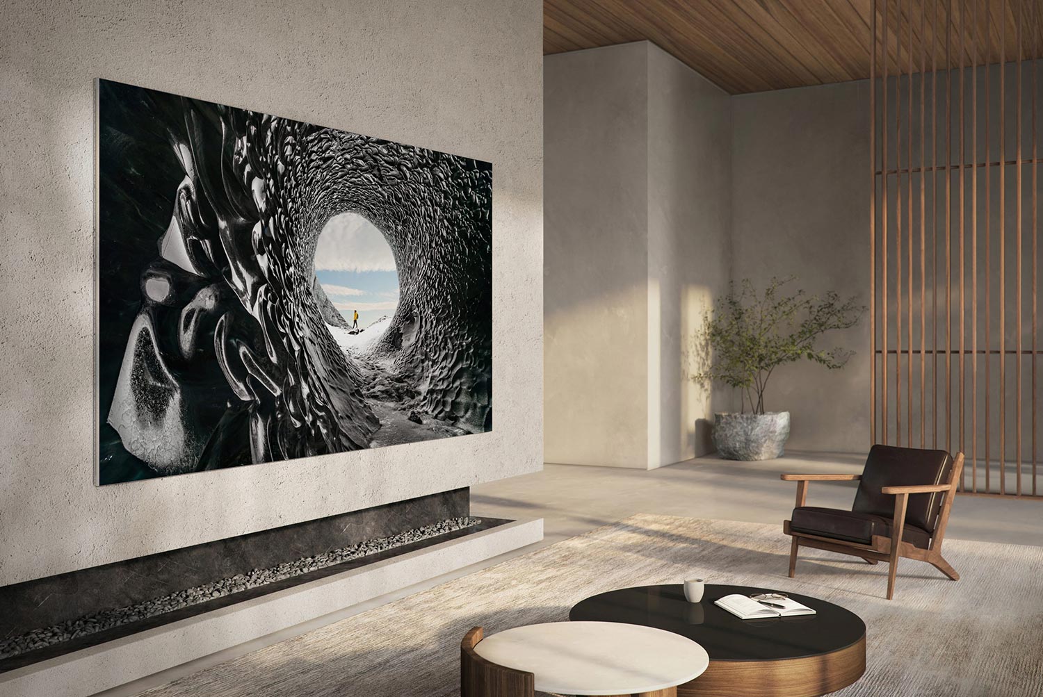 Large wall-mounted TV displaying a surreal ice cave scene in a minimalist living room.