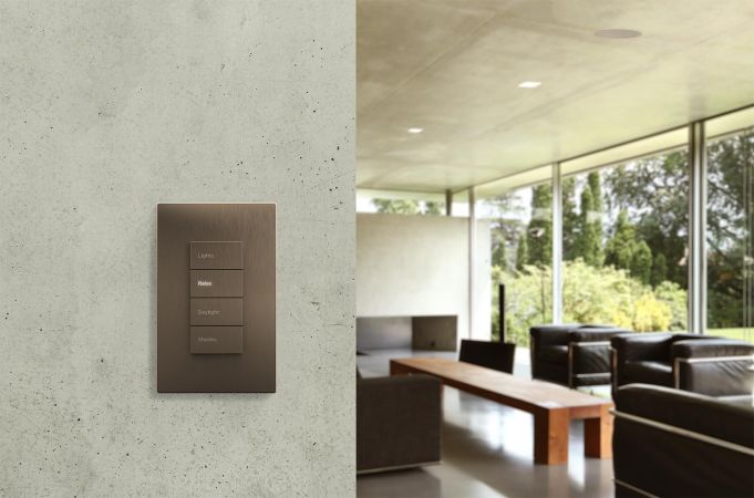 Sleek light control panel on a concrete wall in a modern living room.