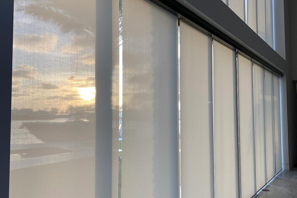 Floor-to-ceiling sheer blinds with soft light filtering through