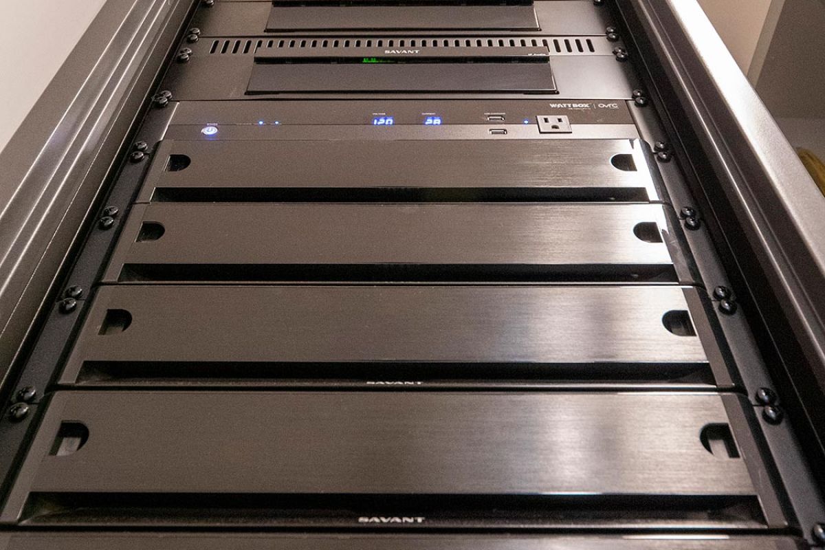 Low-angle view of a tall rack filled with AV and network equipment