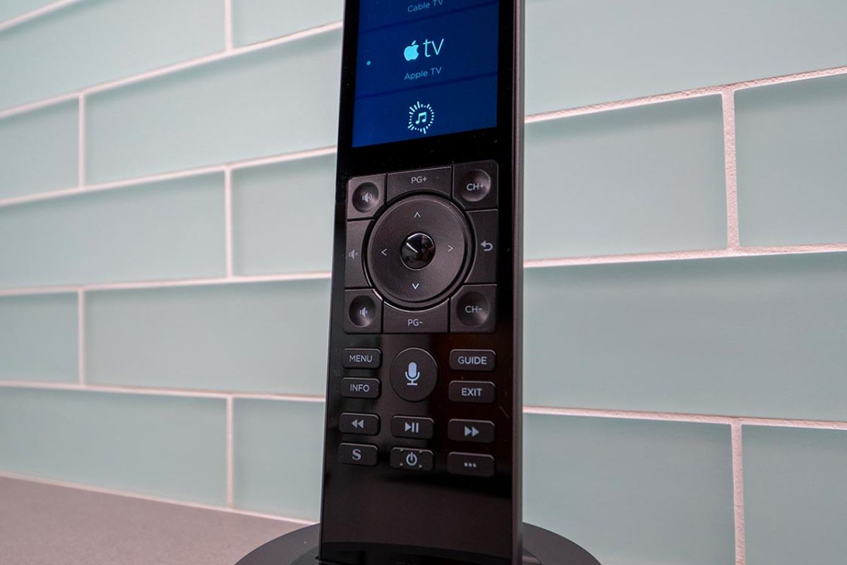 Smart remote on charging base displaying entertainment options