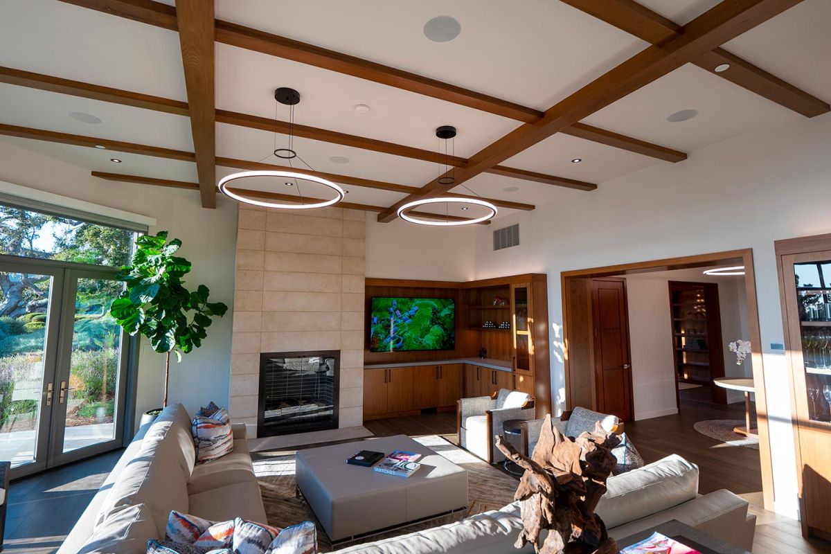 Bright living room with modern lighting and ceiling beams