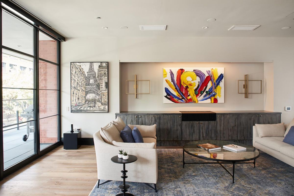 Living room with colorful abstract painting and floor-to-ceiling windows