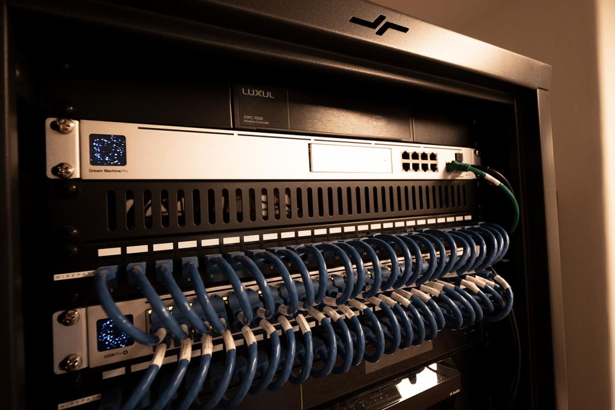 Network rack with neatly organized blue Ethernet cables