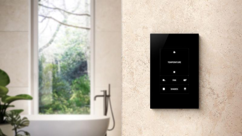 Smart home control panel mounted on a bathroom wall.
