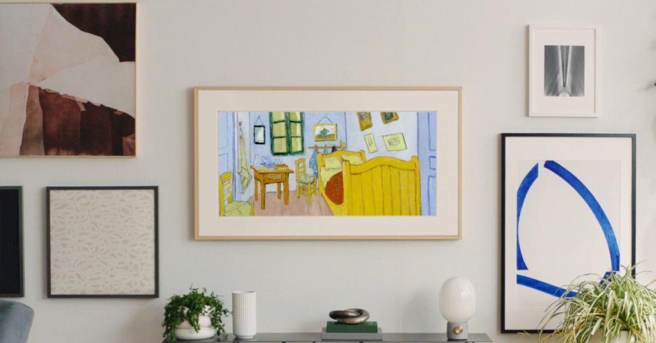 A Samsung Frame TV displaying a Van Gogh painting, seamlessly blending with wall art.