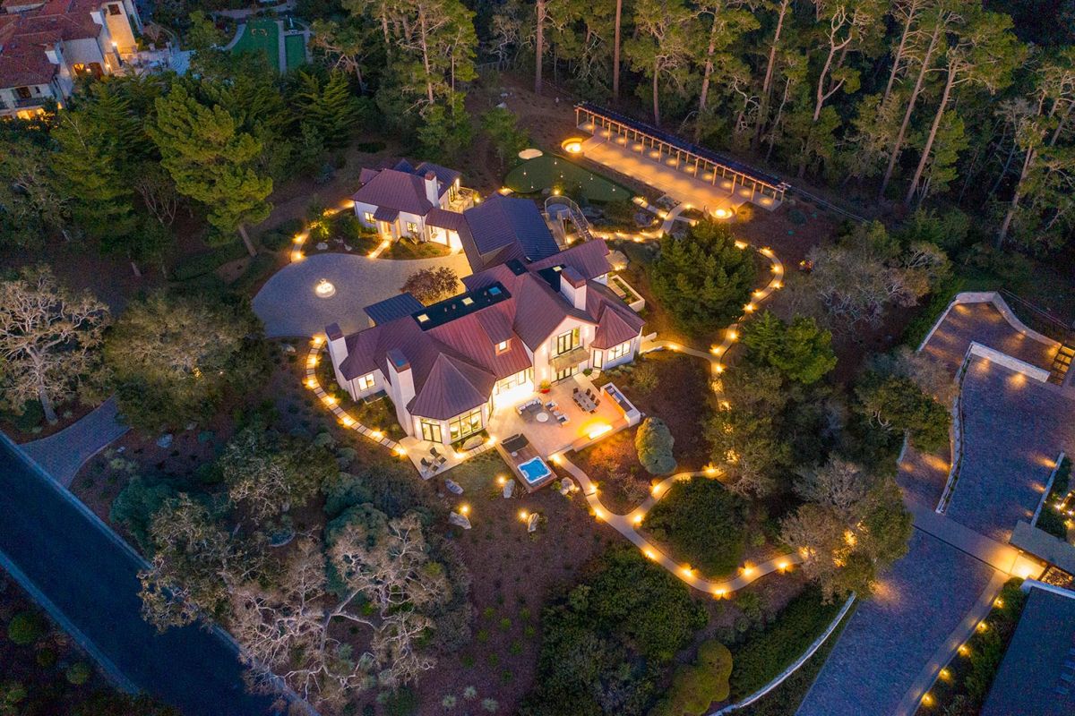 Luxurious home at sunset with glowing landscape lighting