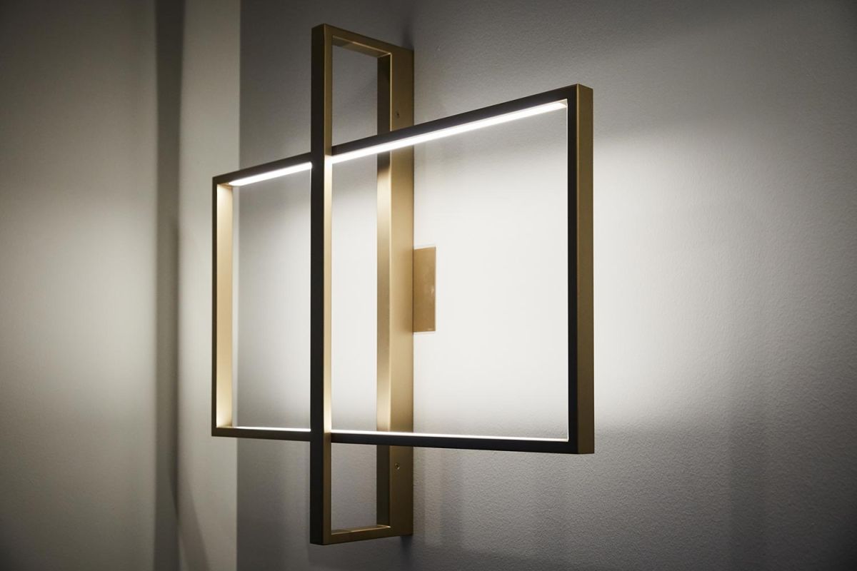 Gold geometric wall light with integrated LED on white wall