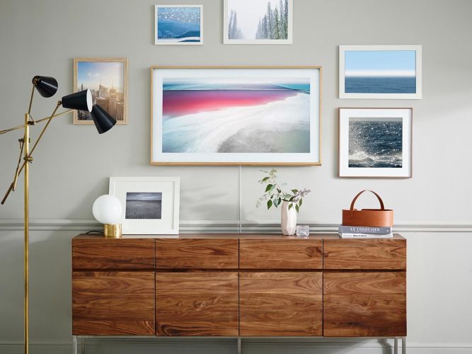 A Samsung Frame TV displaying digital artwork, blending into a stylish living room decor.