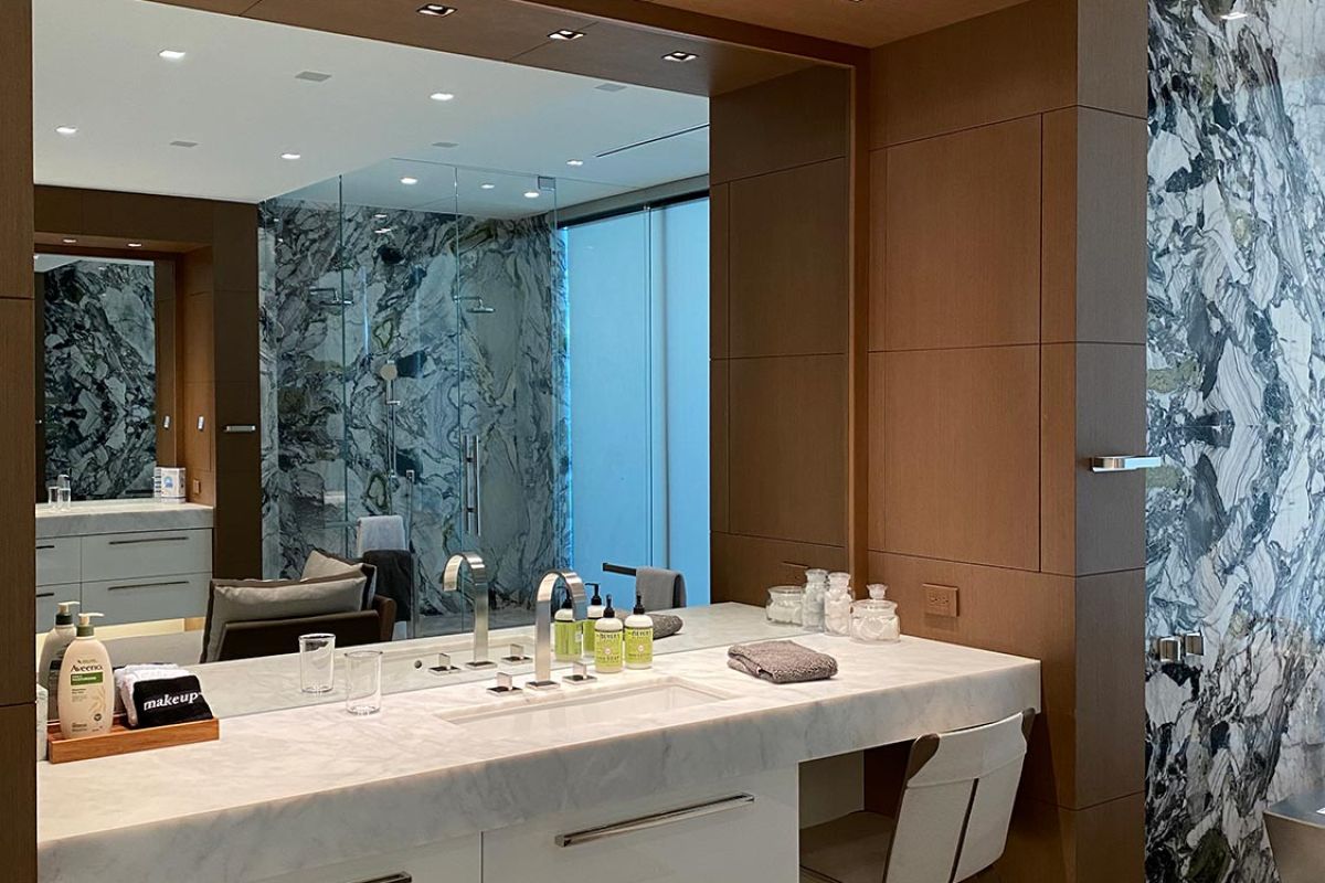 Luxurious bathroom vanity with marble counter and wood paneling