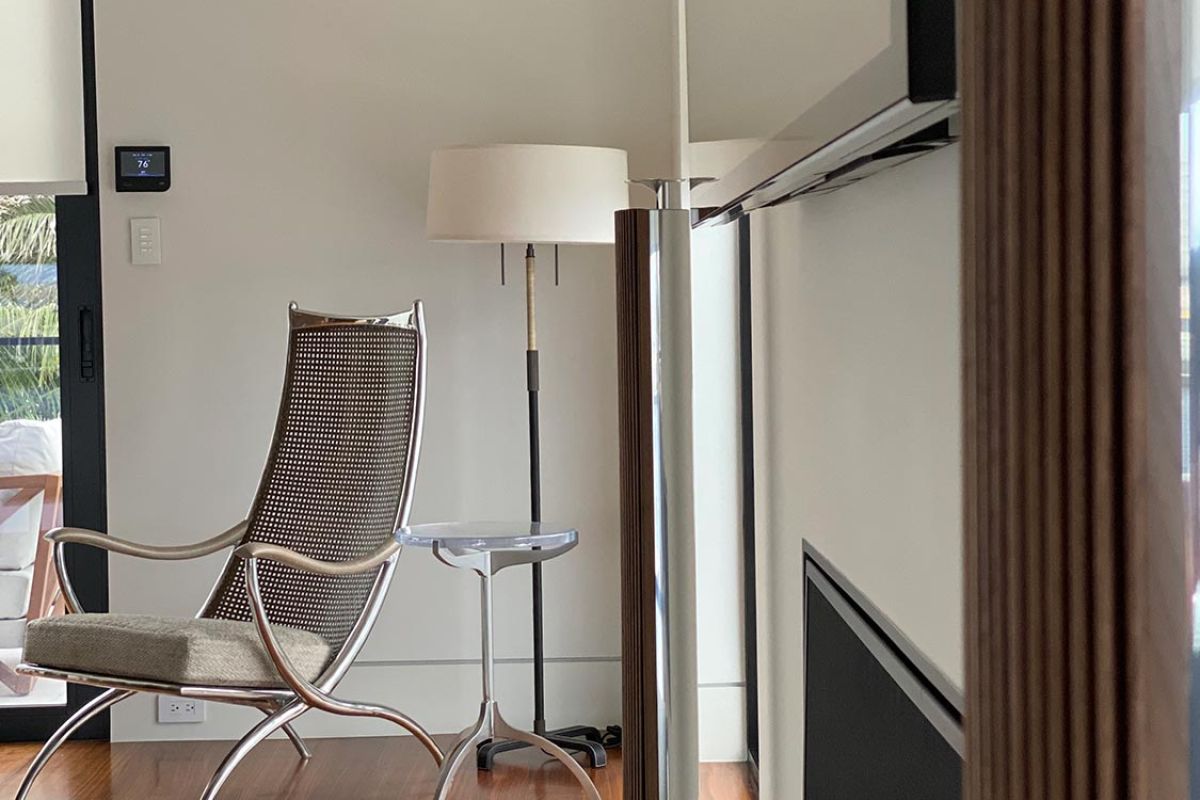 Designer lounge chair beside window in minimalist room