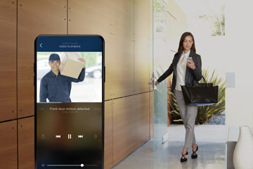 Woman picking up a delivery while seeing delivery man on the phone from previous footage