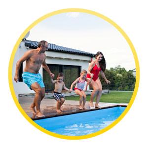 family of four jumping in the pool together