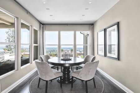 dinning table with 4 chairs facing the outside view