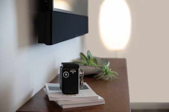 camera on top of books on top of a table under the tv side view